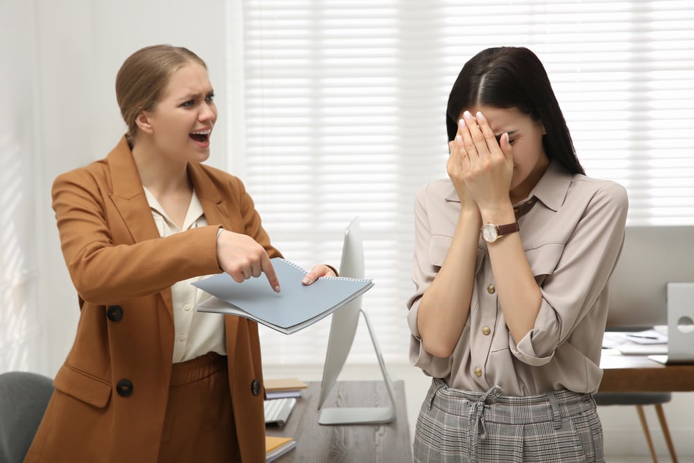 A boss shouting at an employee in a toxic culture