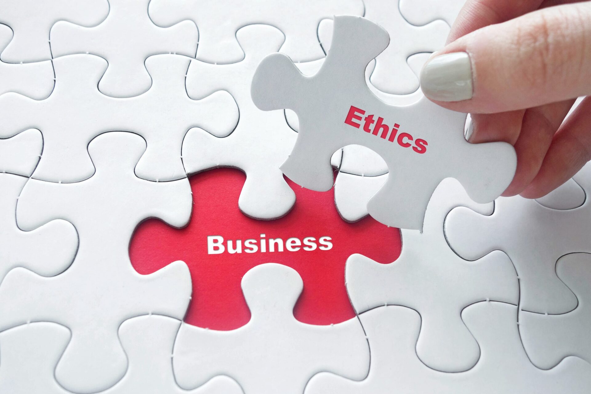 Photo of a puzzle piece saying 'ethics' replacing a piece saying 'Business'
