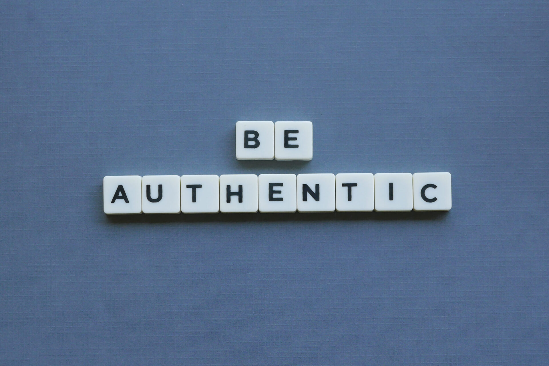 Photo of tiles that spell out 'BE AUTHENTIC'