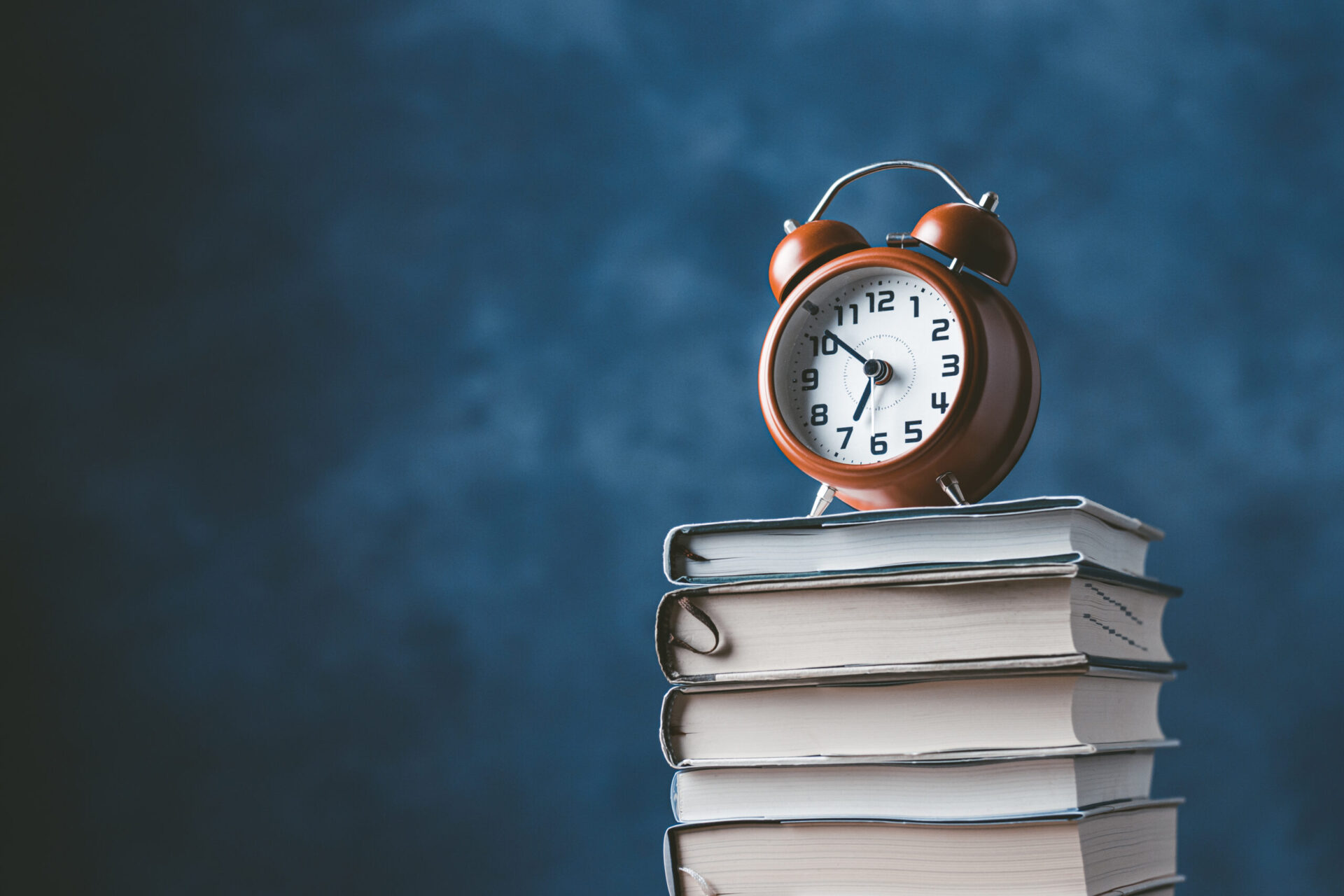Photo of a clock on top of some books