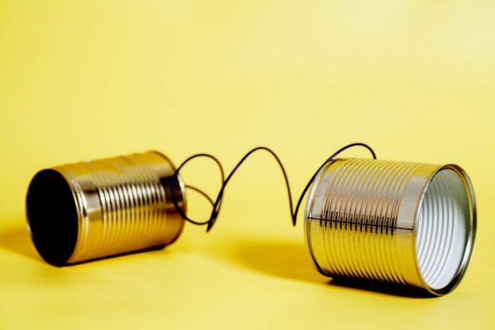 Photo of two tin cans attached with string