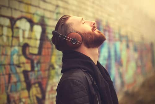 man in headphones listening to music outdoors