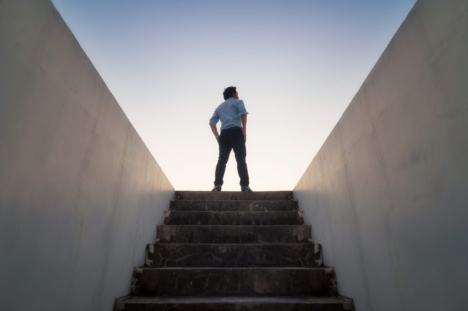 Photo of someone standing at the top of some stairs