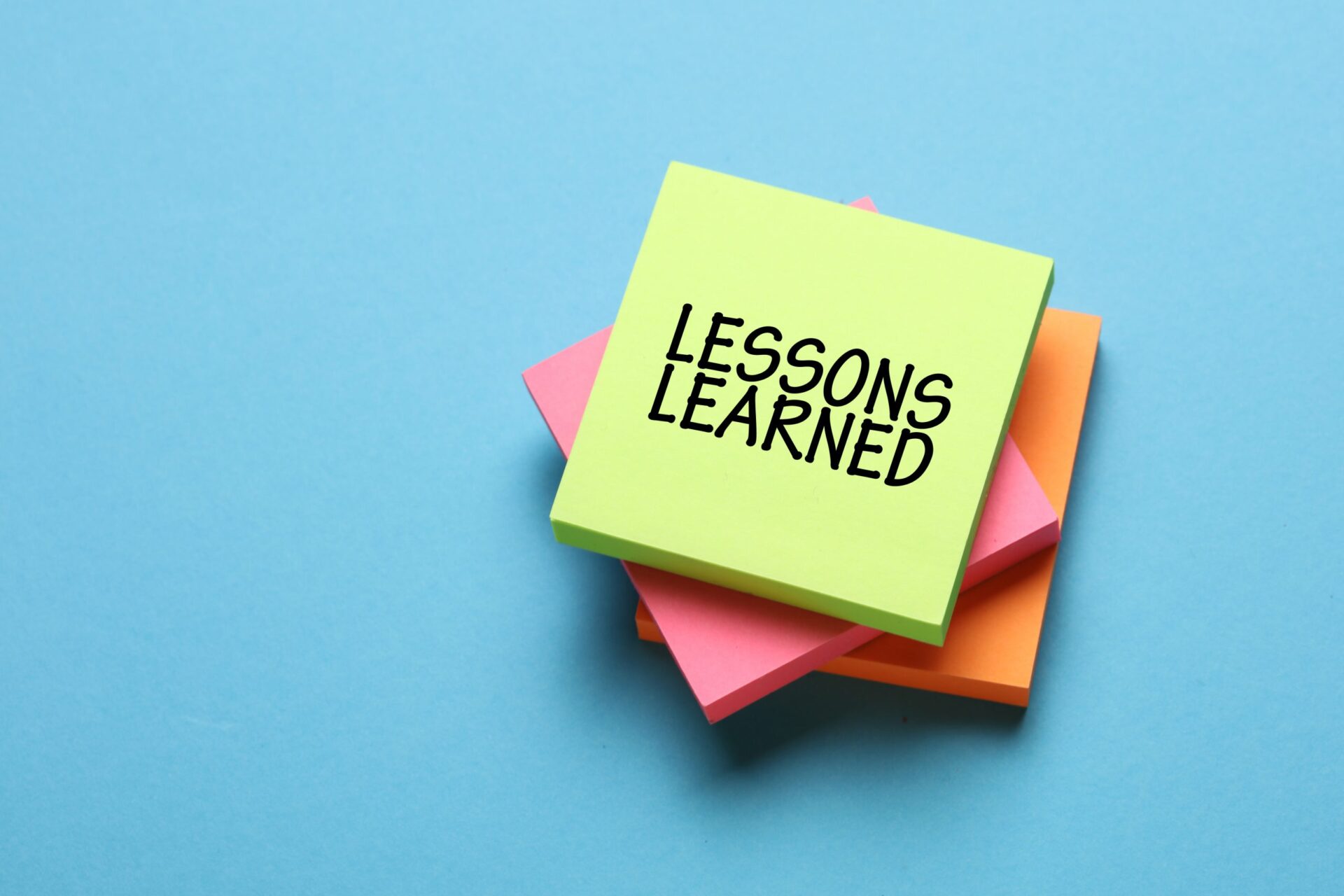 Photo of a post-it note saying 'Lessons Learned'