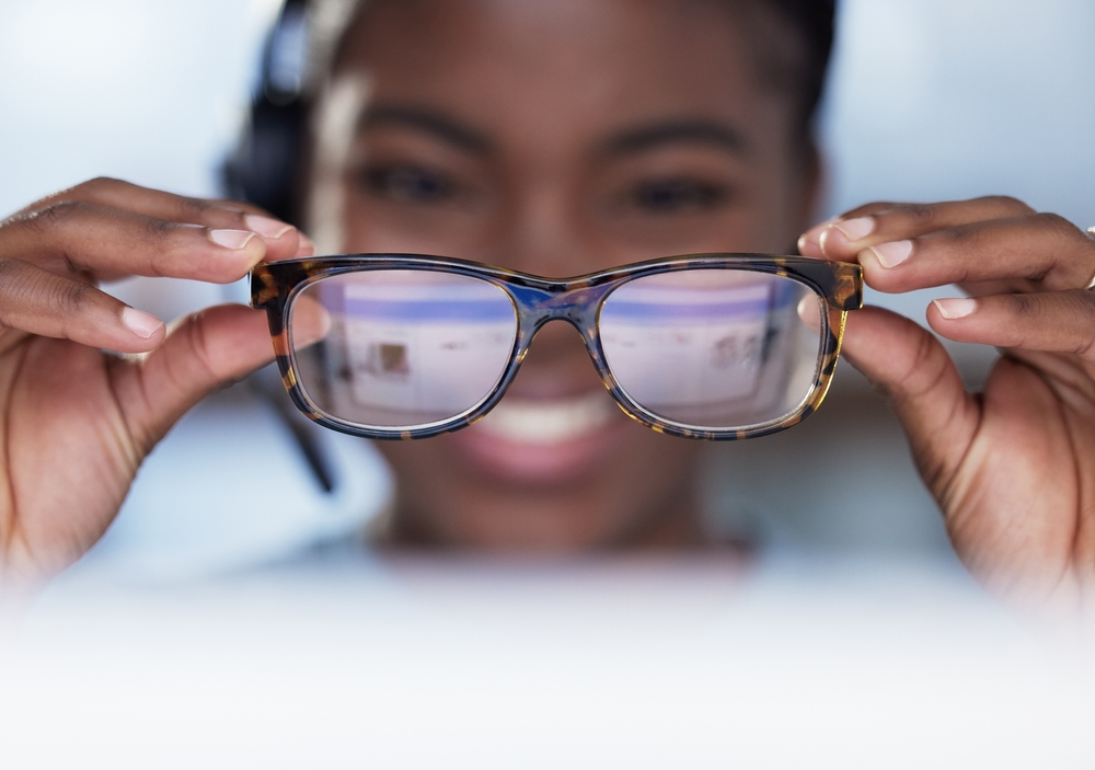 Woman holding her glasses